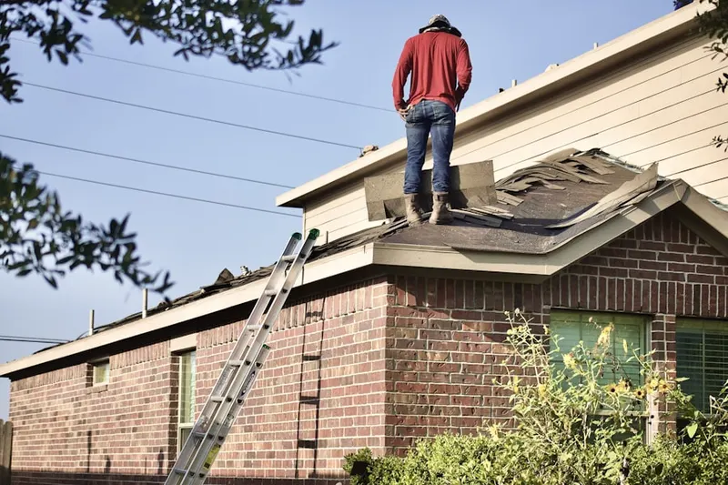 Professional roofer working on a residential roof in West Fargo